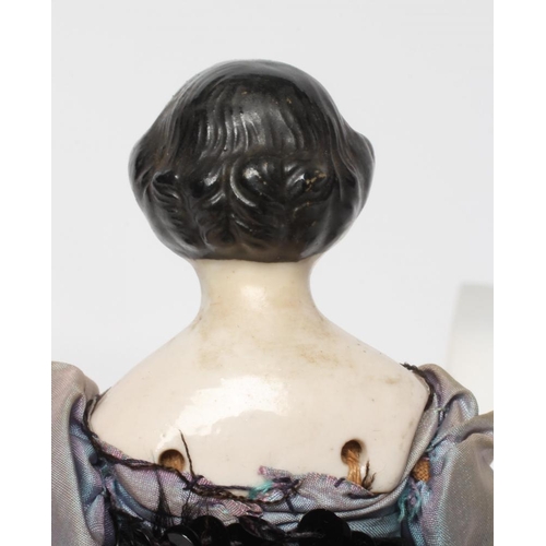 98 - A china shoulder head doll, c.1880, with moulded hair, painted features, fabric body, china lower li... 