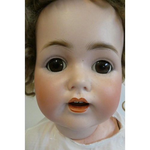 99 - A J.D. Kestner bisque socket head character doll, with brown glass sleeping eyes, open mouth, applie... 