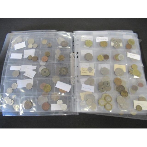 725 - FOLDER OF WORLD COINS