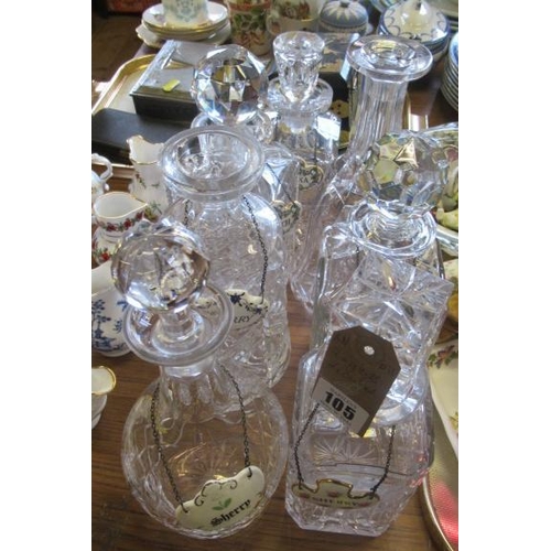 105 - SEVEN GLASS DECANTERS