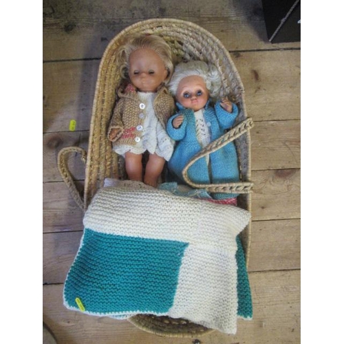 61 - TWO DOLLS AND KNITTED CLOTHES IN WOVEN BASKET