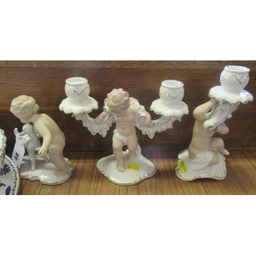 98 - TWO PUTTI CANDLESTICKS AND ANOTHER PUTTI FIGURE