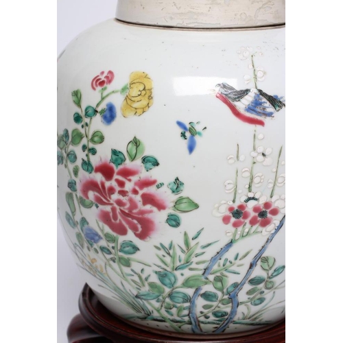 13 - A CHINESE PORCELAIN LARGE JAR AND COVER painted in colours with a finch perched upon a blossoming br... 