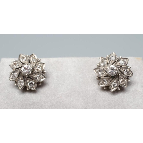 176 - A PAIR OF DIAMOND CLUSTER EAR STUDS, the central round brilliant cut stones each of approximately 0.... 