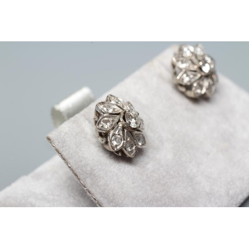 176 - A PAIR OF DIAMOND CLUSTER EAR STUDS, the central round brilliant cut stones each of approximately 0.... 