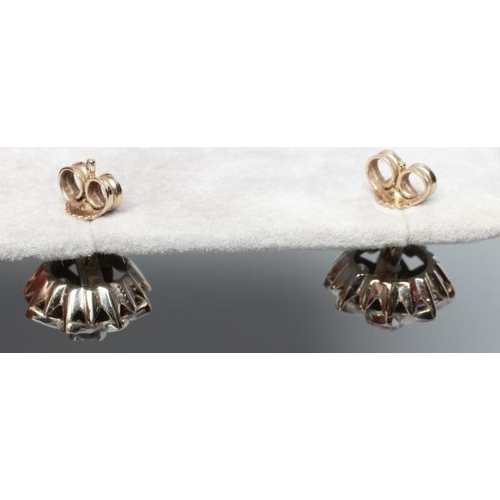 176 - A PAIR OF DIAMOND CLUSTER EAR STUDS, the central round brilliant cut stones each of approximately 0.... 