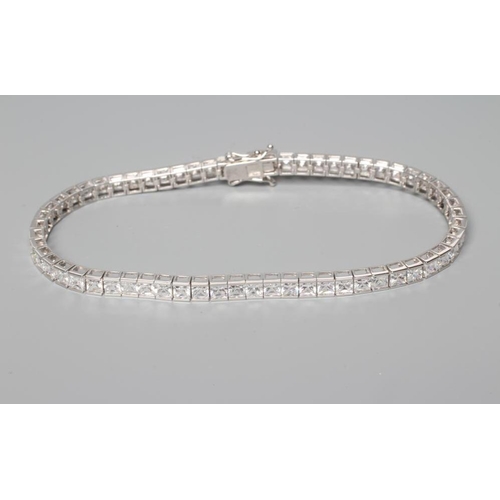 180 - A TENNIS BRACELET, the sixty one cubic zirconia channel set to a plain white frame, stamped 375 (Est... 