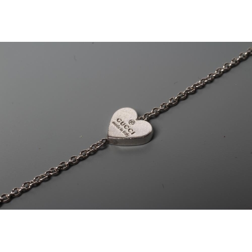 183 - A GUCCI SILVER CHAIN NECKLACE, the three heart panels stamped with the Gucci logo and interspersed w... 