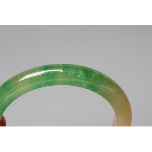 187 - A POLISHED JADE BANGLE of D form, 37g, together with a silver mounted jade Shou pendant, stamped 925... 