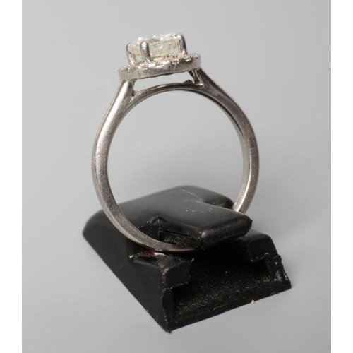 188 - A DIAMOND CLUSTER RING, the central brilliant cut stone of approximately 0.80cts claw set to an open... 