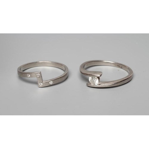 192 - A PALLADIUM DIAMOND ENGAGEMENT AND MATCHING WEDDING RINGS, the modern crossover with a tension set r... 