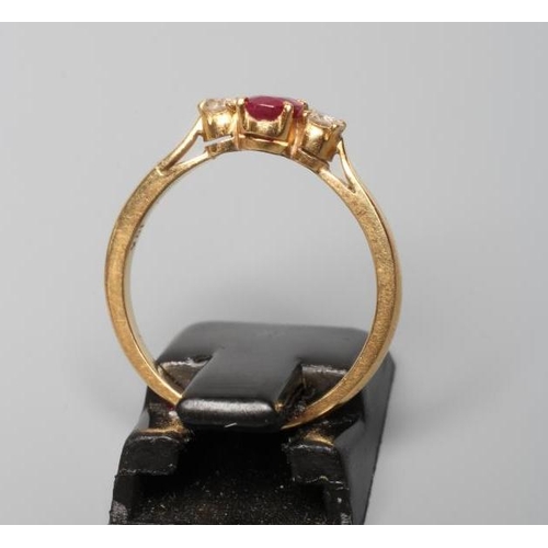 197 - A RUBY AND DIAMOND THREE STONE RING, the central oval facet cut ruby claw set and flanked by two sma... 