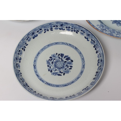 2 - TWO CHINESE PORCELAIN SAUCER DISHES painted in underglaze blue with a flower spray within a diapered... 