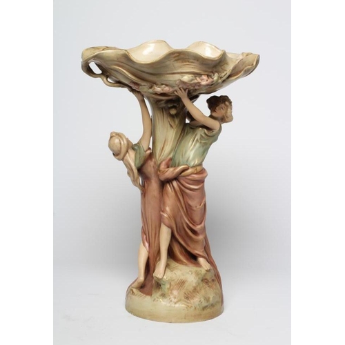 40 - A ROYAL DUX PORCELAIN ART NOUVEAU FIGURAL CENTREPIECE modelled as two young maidens holding aloft a ... 