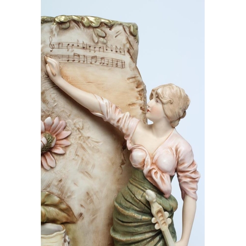 42 - A ROYAL DUX PORCELAIN FIGURAL VASE, early 20th century, modelled as a young maiden holding a long ne... 