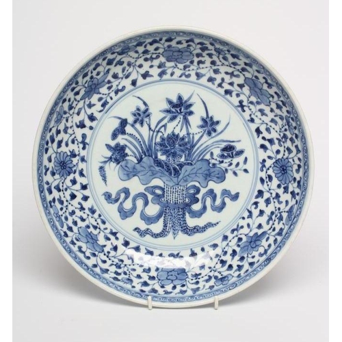 5 - A CHINESE PORCELAIN DISH of plain circular form, painted in underglaze blue with a central ribbon ti... 