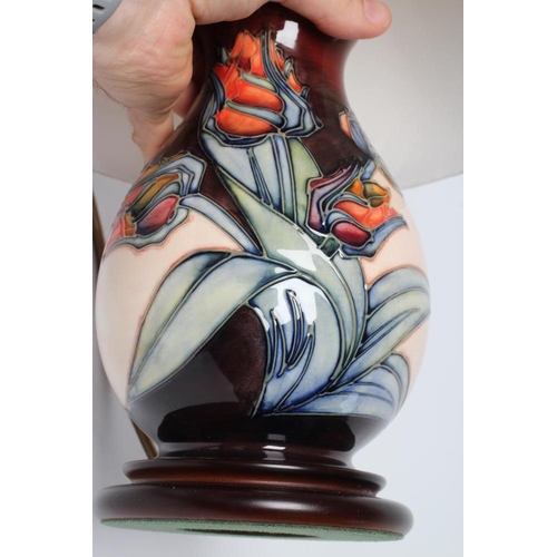 76 - A MOORCROFT POTTERY RED TULIP PATTERN ELECTRIC TABLE LAMP BASE, modern, of ovoid form designed by Sa... 