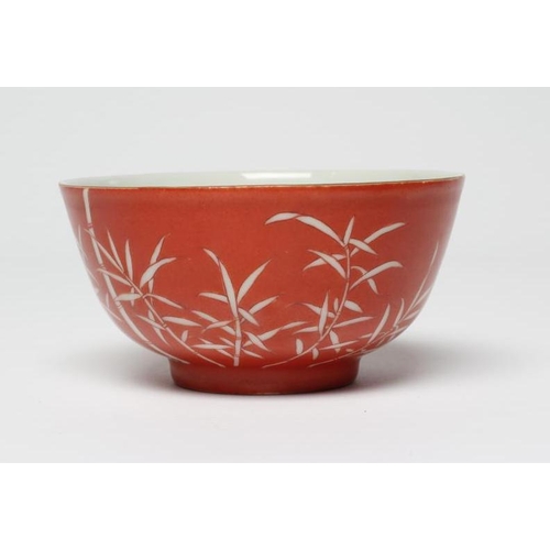 8 - A CHINESE PORCELAIN SMALL BOWL, the iron red exterior reverse decorated with bamboo, six character m... 