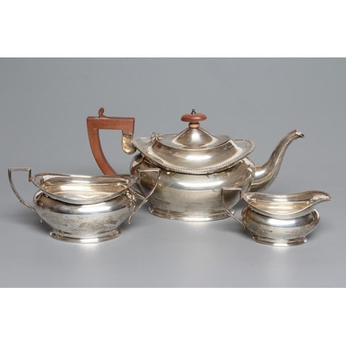 96 - A SILVER THREE PIECE TEA SERVICE, by Henry Clifford Davis, Birmingham 1926, of oval baluster form wi... 