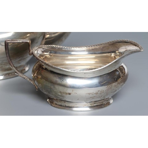 96 - A SILVER THREE PIECE TEA SERVICE, by Henry Clifford Davis, Birmingham 1926, of oval baluster form wi... 