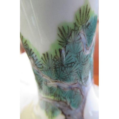 7 - A CHINESE PORCELAIN BOTTLE VASE painted in colours with a vignette of three figures below a gnarled ... 