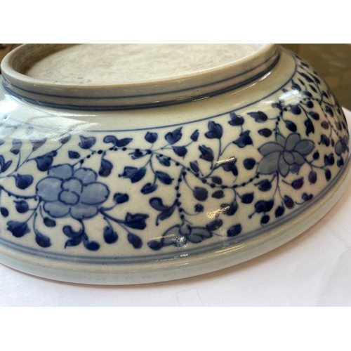 5 - A CHINESE PORCELAIN DISH of plain circular form, painted in underglaze blue with a central ribbon ti... 