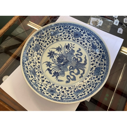 5 - A CHINESE PORCELAIN DISH of plain circular form, painted in underglaze blue with a central ribbon ti... 