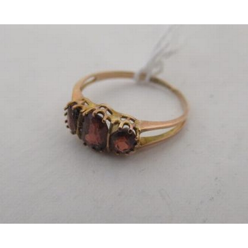 165 - 9CT GOLD AND GARNET RING