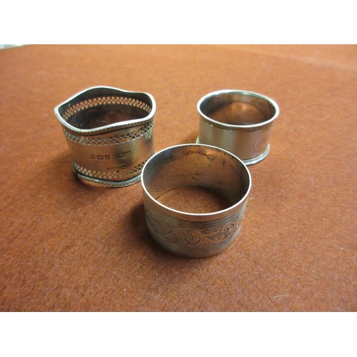 244 - THREE SILVER NAPKIN RINGS