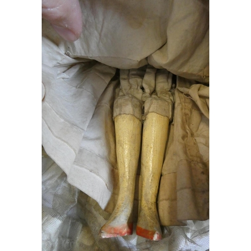 10 - A Victorian peg doll with carved and painted head and torso, cloth upper limbs and carved wooden low... 