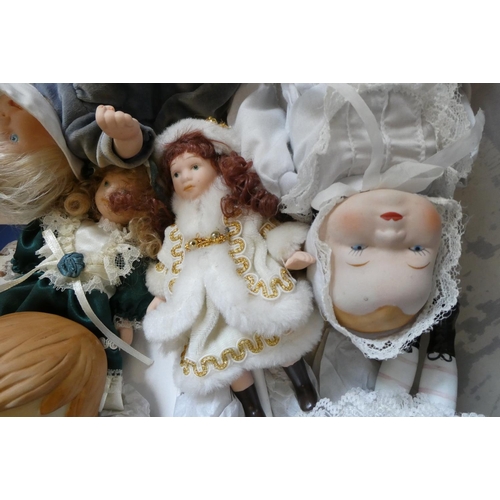 113 - A box of small collectors dolls including a Hummel style doll and all bisque examples (Est. plus 24%... 