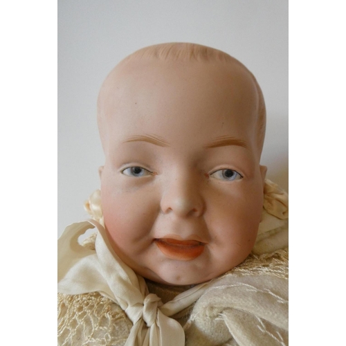 119 - A German bisque socket head character doll, with painted eyes, moulded open mouth, moulded hair, com... 