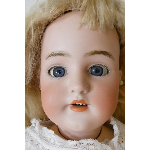 122 - A Simon & Halbig bisque socket head doll, with blue glass sleeping eyes, open mouth, teeth, pierced ... 