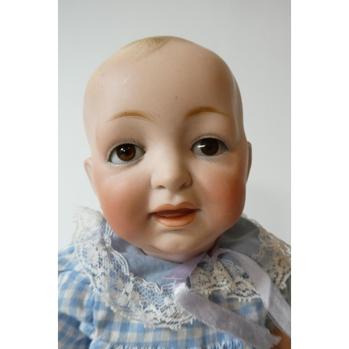 129 - A Kestner bisque socket head character doll, with brown glass sleeping eyes, moulded open mouth, pai... 