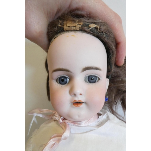 13 - A Simon & Halbig bisque socket head doll with blue glass fixed eyes, open mouth, teeth, pierced ears... 