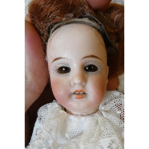 136 - A Henri Rostal bisque socket head doll, with brown glass fixed eyes, open mouth, auburn wig, composi... 