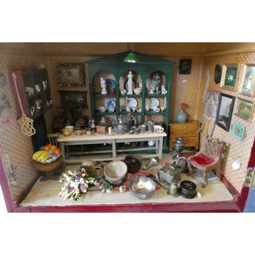 138 - A doll's house and contents fitted as an antiques centre, with exterior signage, the house of painte... 