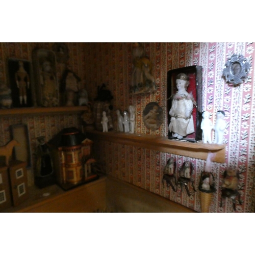 138 - A doll's house and contents fitted as an antiques centre, with exterior signage, the house of painte... 