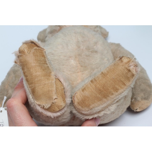 144 - A pre-war pink jointed teddy bear, with shoe button eyes, sewn nose and cloth pads, 16