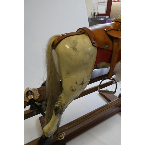 171 - A dappled grey rocking horse, with painted and carved wood body, amber eyes, horse hair mane and tai... 