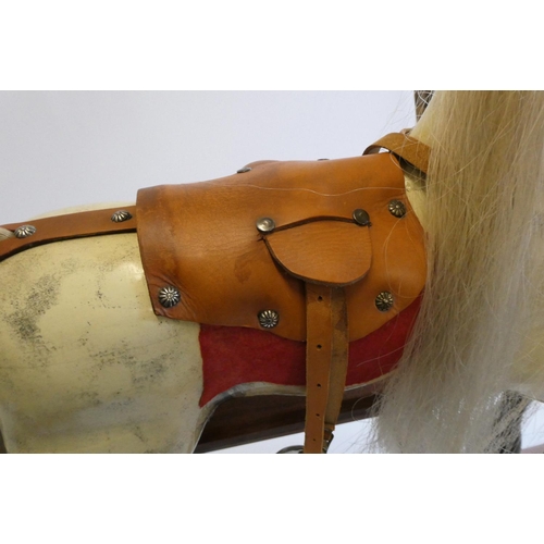 171 - A dappled grey rocking horse, with painted and carved wood body, amber eyes, horse hair mane and tai... 