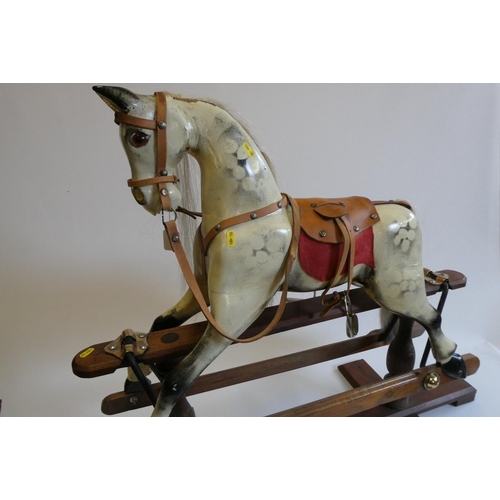 171 - A dappled grey rocking horse, with painted and carved wood body, amber eyes, horse hair mane and tai... 