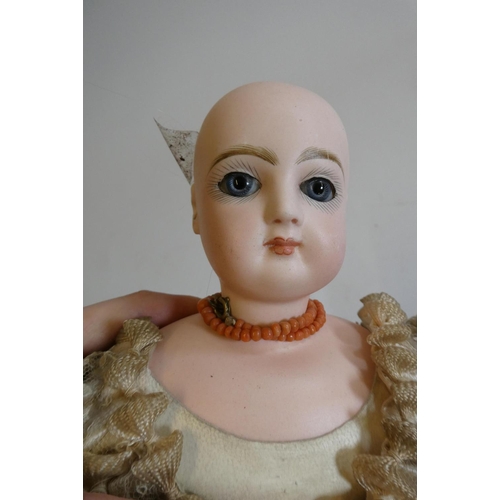 21 - A Jumeau bisque shoulder head doll with blue glass fixed eyes, closed mouth, pierced ears, jointed n... 