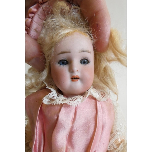 23 - A Kammer & Reinhardt bisque socket head doll with blue glass sleeping eyes, open mouth, teeth, blond... 