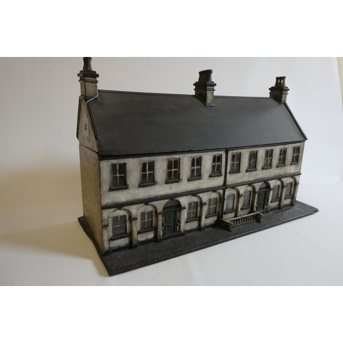 28 - A Victorian doll's house/trunk in the form of a two house street, with a pillared facade, twenty gla... 