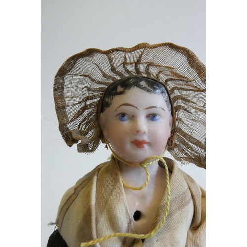 31 - A possibly Francois Gaultier fisherwoman bisque shoulder head doll with blue moulded eyes, black mou... 