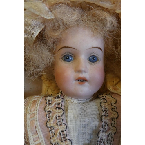 38 - A Theodor Recknagel bisque socket head doll, rare in original box, with blue glass fixed eyes, open ... 