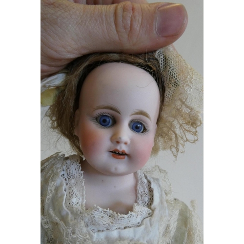 39 - An early Armand Marseille bisque shoulder head doll with blue glass fixed eyes, open mouth, teeth, a... 