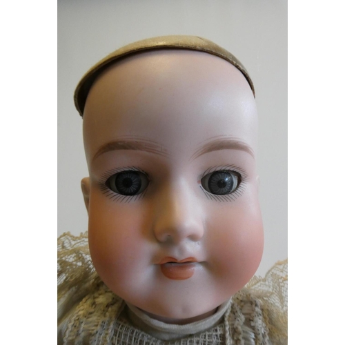 43 - An Armand Marseille bisque socket head doll with blue glass sleeping eyes, open mouth, teeth, blond ... 