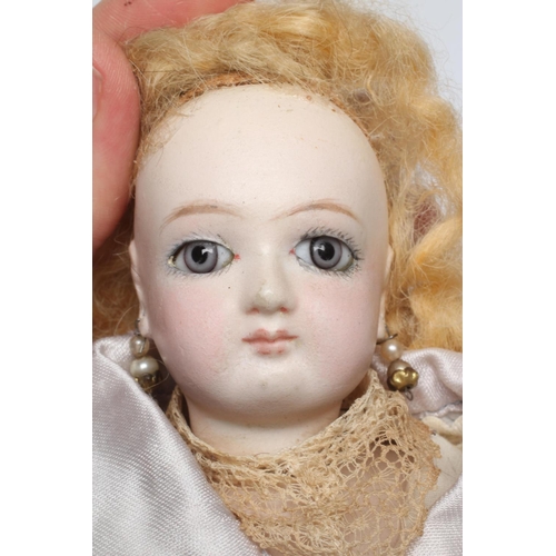 46 - A French bisque swivel neck shoulder head fashion doll, possibly Jumeau, with blue glass fixed eyes,... 